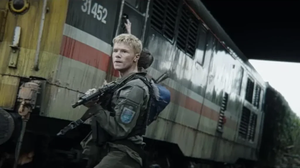 28 Years Later 2025 Movie Review showing a man carrying an assault rifle – Image Source: TMDB