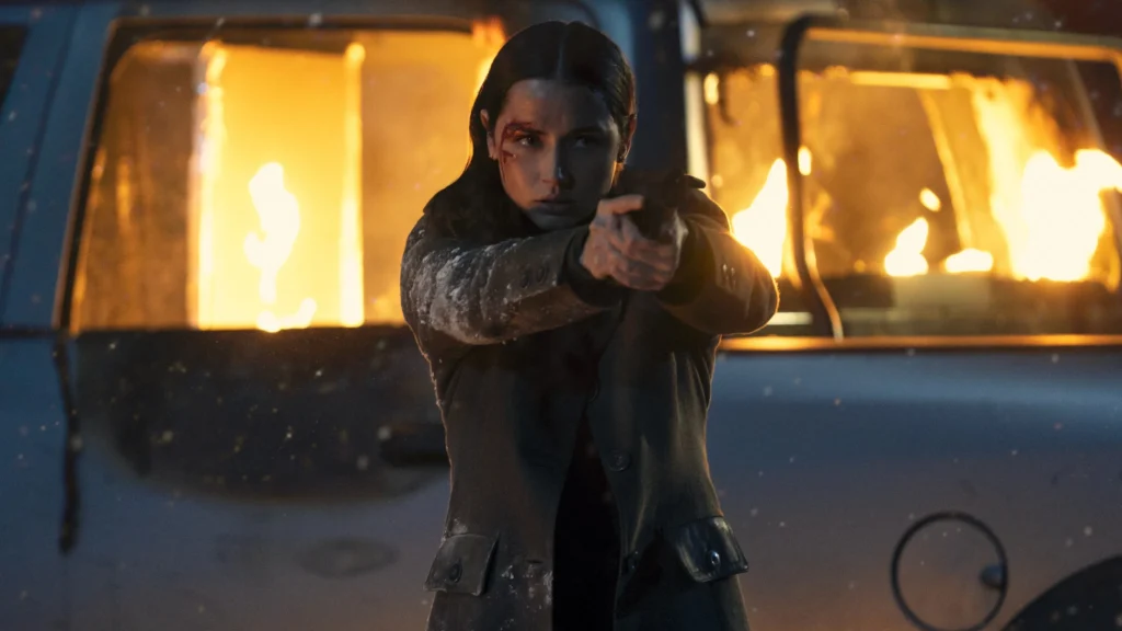Showing lead actresses ana de armas holding an assault rifle.Image Credit: © TMDb (www.themoviedb.org) – Used for informational/review purposes only.