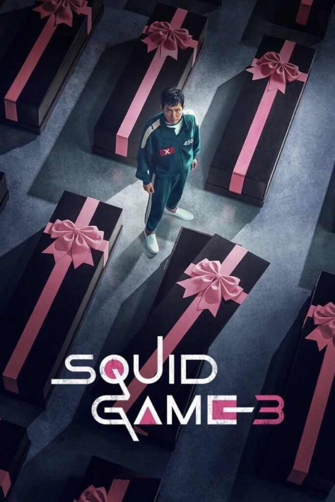Squid Game Season 3 showing Main Character Standing between coffins looking up.Image Credit: © TMDb (www.themoviedb.org) – Used for informational/review purposes only.