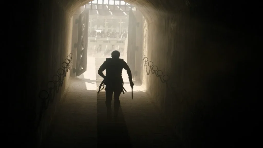 Main |Character hero coming out in the arena .Image Credit: Β© TMDb (www.themoviedb.org) β Used for informational/review purposes only.