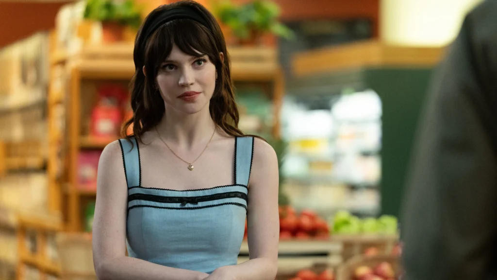 Sophie Thatcher standing a Local Store Scene From Movie Companion .Image Credit: ยฉ TMDb (www.themoviedb.org) โ Used for informational/review purposes only.